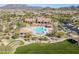 Aerial view of community pool, clubhouse, and surrounding landscape at 8725 E Indigo St, Mesa, AZ 85207