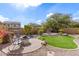 Relaxing backyard with patio, fire pit, and lush landscaping at 8725 E Indigo St, Mesa, AZ 85207