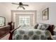 Bright bedroom with a leafy print comforter and plantation shutters at 8725 E Indigo St, Mesa, AZ 85207