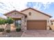 One-story home with stone accents and a brown garage door at 8725 E Indigo St, Mesa, AZ 85207