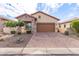 Tan house with brown garage door and brick driveway at 8725 E Indigo St, Mesa, AZ 85207