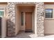 Front entrance with stone archway and brown door at 8725 E Indigo St, Mesa, AZ 85207