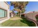 Landscaped backyard with grassy area and mature trees at 9127 W Kimberly Way, Peoria, AZ 85382