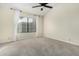 Bright bedroom with vaulted ceiling, ceiling fan, and large window at 9127 W Kimberly Way, Peoria, AZ 85382