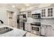 Modern kitchen with stainless steel appliances and white cabinets at 9127 W Kimberly Way, Peoria, AZ 85382