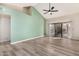 Bright living room with vaulted ceilings, wood-look floors, and sliding glass doors at 9127 W Kimberly Way, Peoria, AZ 85382