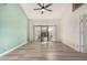 Living room with light walls, wood-look floors, and access to a patio at 9127 W Kimberly Way, Peoria, AZ 85382