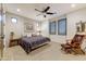 Bedroom with a queen bed, ceiling fan, and plantation shutters at 9505 E Superstition Mountain Dr, Gold Canyon, AZ 85118