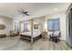 Main bedroom with a large four-poster bed, ceiling fan, and wood flooring at 9505 E Superstition Mountain Dr, Gold Canyon, AZ 85118