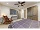 Guest bedroom with a comfortable bed, ceiling fan, and sitting area at 9505 E Superstition Mountain Dr, Gold Canyon, AZ 85118