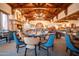 Elegant dining room features exposed wood beams, a stone fireplace, and stylish seating at 9505 E Superstition Mountain Dr, Gold Canyon, AZ 85118