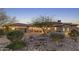 Desert home with landscaped yard, driveway, and two-car garage at 9505 E Superstition Mountain Dr, Gold Canyon, AZ 85118