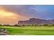 Golf course with mountain backdrop and dramatic sunset sky at 9505 E Superstition Mountain Dr, Gold Canyon, AZ 85118