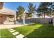 Backyard with kidney-shaped pool and stone pathway at 9745 E Natal Ave, Mesa, AZ 85209