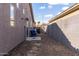 Small gravel backyard with blue chairs and a concrete patio at 9745 E Natal Ave, Mesa, AZ 85209