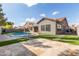 Large backyard with kidney-shaped pool and stone patio at 9745 E Natal Ave, Mesa, AZ 85209