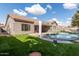 Backyard with kidney-shaped pool and artificial turf at 9745 E Natal Ave, Mesa, AZ 85209