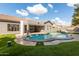 Backyard with kidney-shaped pool and artificial turf at 9745 E Natal Ave, Mesa, AZ 85209