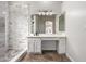 Bathroom with marble shower, vanity with large mirror and tile floor at 9745 E Natal Ave, Mesa, AZ 85209