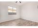 Bright bedroom with wood-look floors and ceiling fan at 9745 E Natal Ave, Mesa, AZ 85209