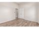 Bedroom with wood-look floors and double door closet at 9745 E Natal Ave, Mesa, AZ 85209