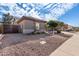 House exterior showcasing desert landscaping and a gated entry at 9745 E Natal Ave, Mesa, AZ 85209