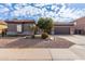 Single-story home with desert landscaping and two-car garage at 9745 E Natal Ave, Mesa, AZ 85209