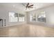 Living room with tile floor, ceiling fan, and large windows at 9745 E Natal Ave, Mesa, AZ 85209