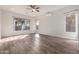 Light-filled living room featuring wood-look floors and a ceiling fan at 9745 E Natal Ave, Mesa, AZ 85209