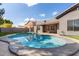 Kidney-shaped pool with surrounding patio and artificial turf at 9745 E Natal Ave, Mesa, AZ 85209