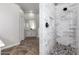 Large walk-in shower with marble tile and pebble floor at 9745 E Natal Ave, Mesa, AZ 85209