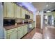 Kitchen with light green cabinets, granite countertops, and stainless steel appliances at 9778 E Barley Rd, Florence, AZ 85132