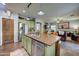 Open kitchen with island, stainless steel appliances, and views to the living room at 9778 E Barley Rd, Florence, AZ 85132