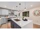 Modern kitchen with white and gray cabinets, quartz countertops and island at 980 Castillo E Dr, Litchfield Park, AZ 85340