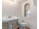 Updated half bathroom with pedestal sink and arch window at 10101 N 91St Ave # 136, Peoria, AZ 85345