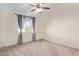 Well-lit bedroom with carpet, ceiling fan and window coverings at 10101 N 91St Ave # 136, Peoria, AZ 85345