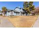 Front view of a light blue house with a yard and sidewalk at 10101 N 91St Ave # 136, Peoria, AZ 85345