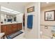 Bathroom featuring a wood vanity, blue rug, and coordinated blue towels at 10206 N 105Th Way, Scottsdale, AZ 85258