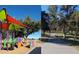 Community park featuring colorful playground equipment, walking path and mature trees for outdoor activities at 10206 N 105Th Way, Scottsdale, AZ 85258