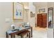 Hallway with art display table and large front door at 10206 N 105Th Way, Scottsdale, AZ 85258