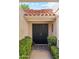 Welcoming front entrance featuring dual black doors, terra cotta roof tiles and attractive landscaping at 10206 N 105Th Way, Scottsdale, AZ 85258