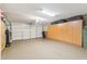 Spacious garage featuring ample storage cabinets, an epoxy floor, and a large garage door at 10206 N 105Th Way, Scottsdale, AZ 85258