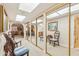 Bright hallway with carpet, mirrored closets, and two chairs with striped cushions at 10206 N 105Th Way, Scottsdale, AZ 85258