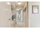 Hallway featuring tile floor and laundry room with a washer and dryer at 10206 N 105Th Way, Scottsdale, AZ 85258