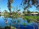 Scenic lake view featuring waterfront homes, palm trees, and a paddle boat under a clear blue sky at 10206 N 105Th Way, Scottsdale, AZ 85258