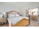 Bright bedroom with a wooden frame bed and access to a private balcony at 10410 N Cave Creek Rd # 2060, Phoenix, AZ 85020