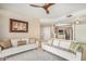 Living room with two white sofas, a fireplace, and access to a balcony at 10410 N Cave Creek Rd # 2060, Phoenix, AZ 85020