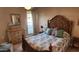 Guest bedroom with ornate wooden bed frame and ample natural light at 10646 W Boswell Blvd, Sun City, AZ 85373