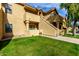 Condo building exterior with stairs leading to individual units and a well-maintained lawn at 1126 W Elliot Rd # 1058, Chandler, AZ 85224