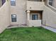 Tan stucco condo building with grassy area and walkway at 1126 W Elliot Rd # 1058, Chandler, AZ 85224